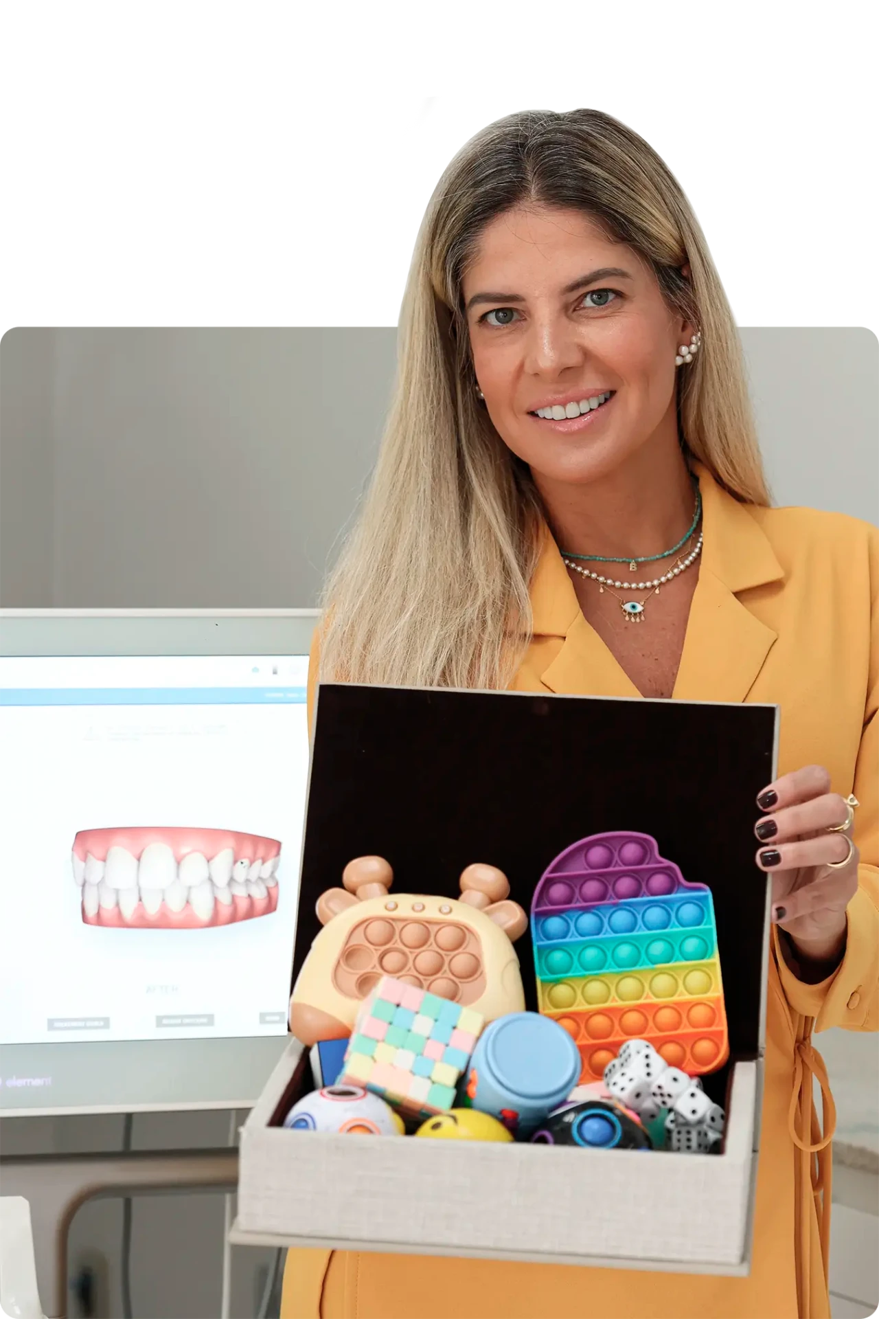 Dra. Bruna Cruz apresentando o escaneamento digital e a caixa de brinquedos do consultório